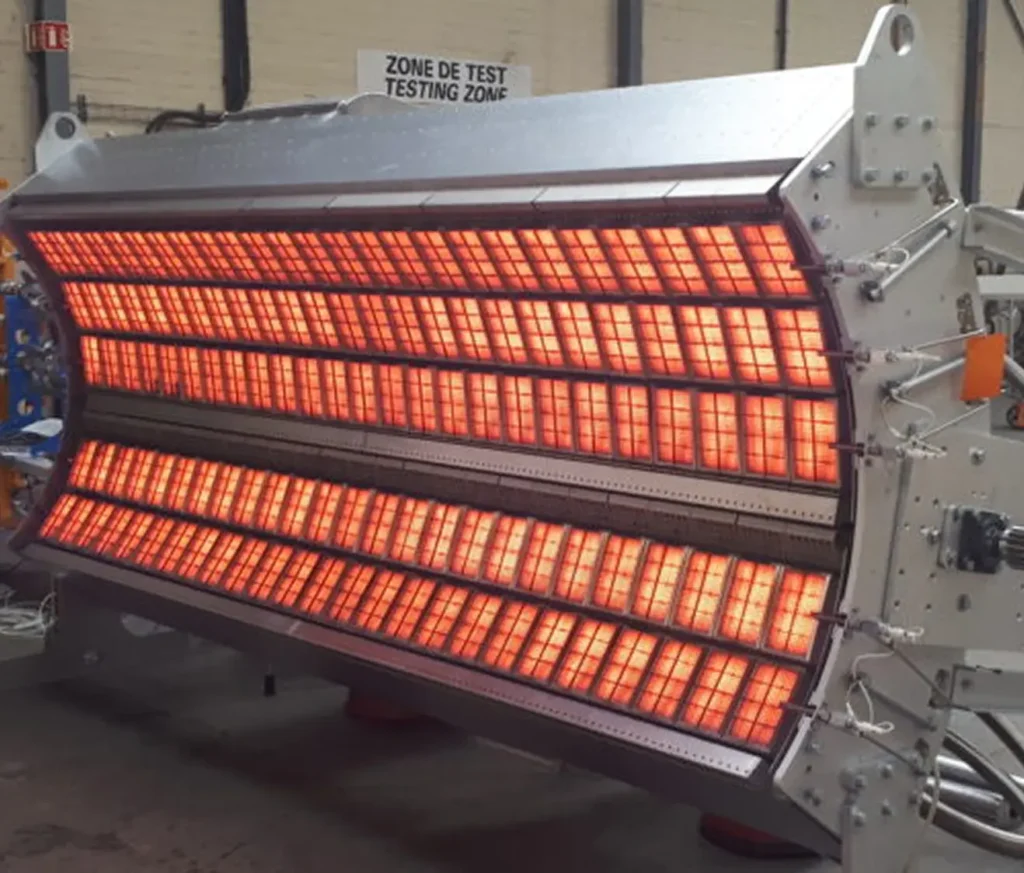 Large metallic infrared dryer emitting red light.