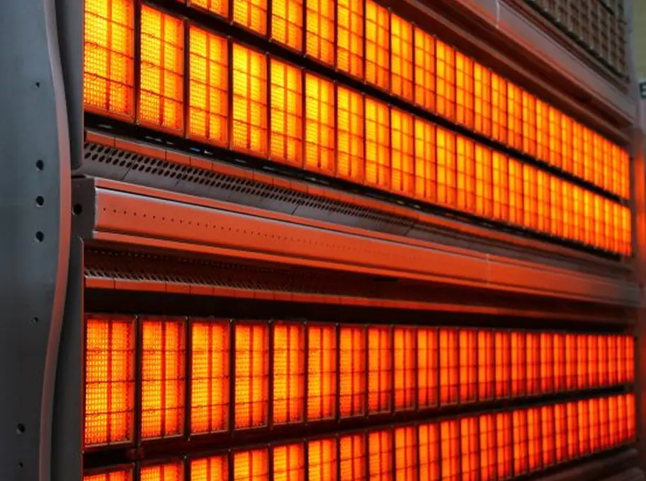 Close-up of industrial infrared heating panels glowing bright orange